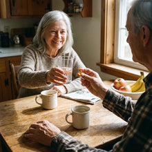 Senior couple at breakfast taking a softgel with water